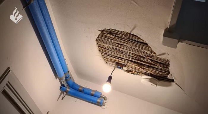 Hole in ceiling after explosion at porch house in Amsterdam West